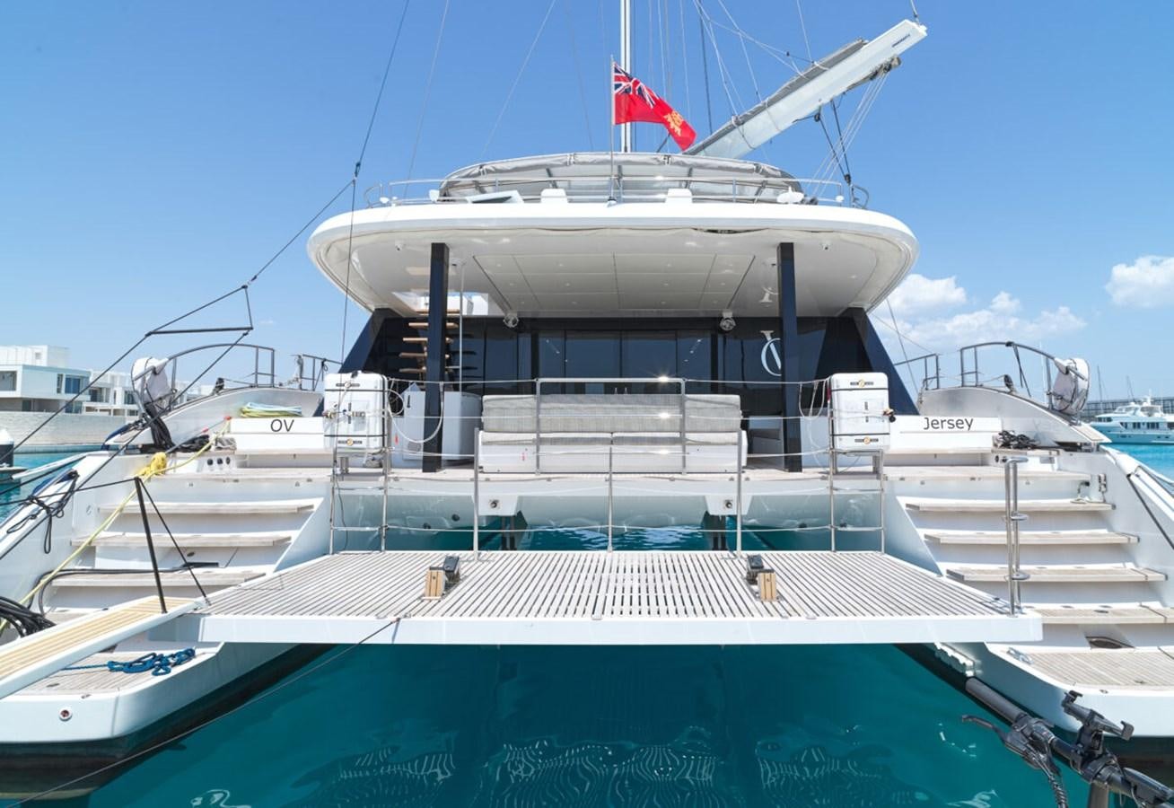 a large white boat with a flag on the front aboard SUNREEF 70 SAIL - 2023 "OV Yacht for Sale