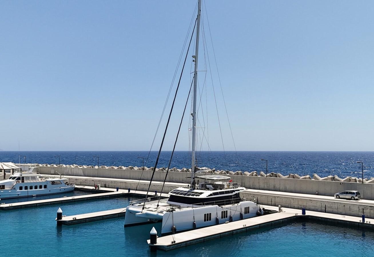 a sailboat docked at a pier aboard SUNREEF 70 SAIL - 2023 "OV Yacht for Sale