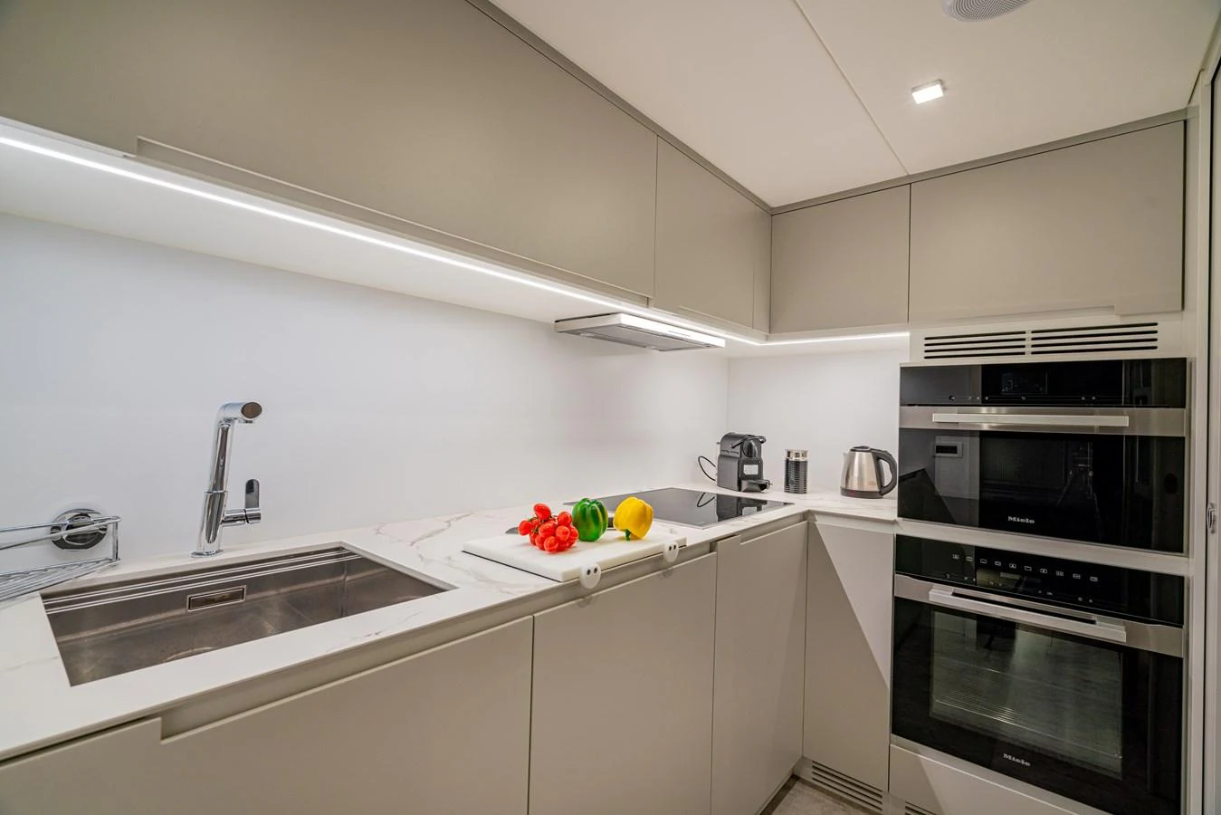 a kitchen with white cabinets aboard SILVER BULLET Yacht for Sale