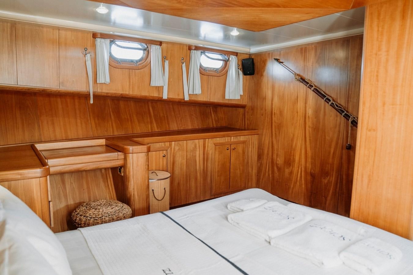 a room with wooden cabinets aboard CUSTOM MADE MOTORSAILER Yacht for Sale