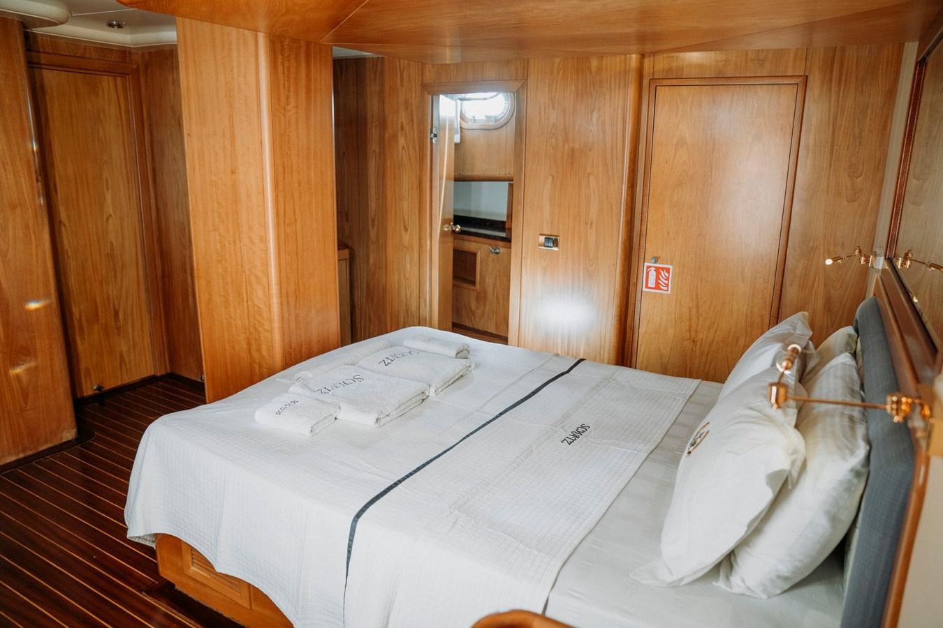 a room with a bed and a mirror aboard CUSTOM MADE MOTORSAILER Yacht for Sale