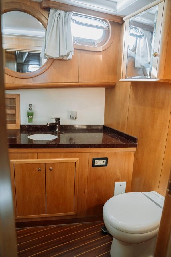 a bathroom with a toilet and a sink aboard CUSTOM MADE MOTORSAILER Yacht for Sale