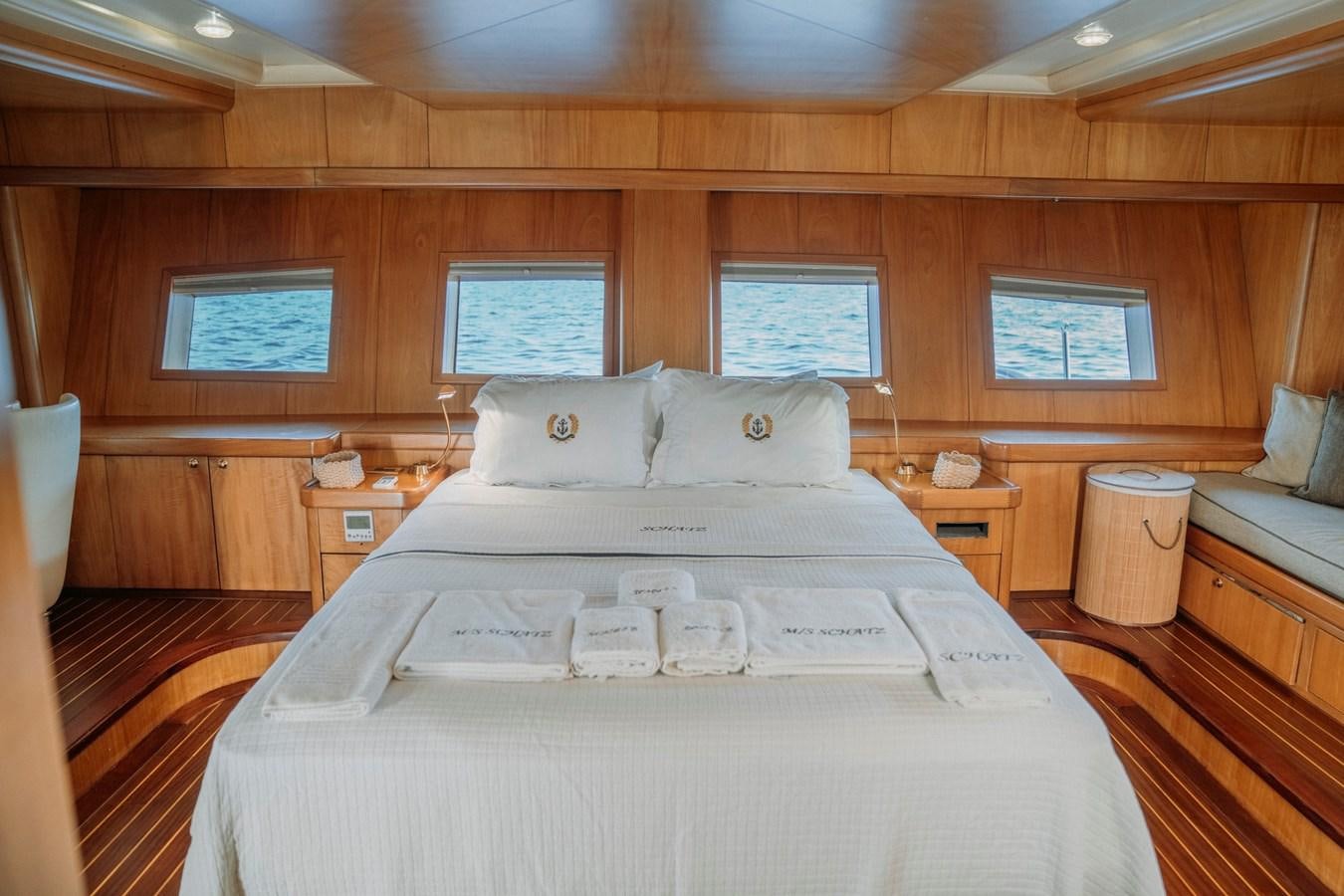 a bed with a white sheet and pillows aboard CUSTOM MADE MOTORSAILER Yacht for Sale