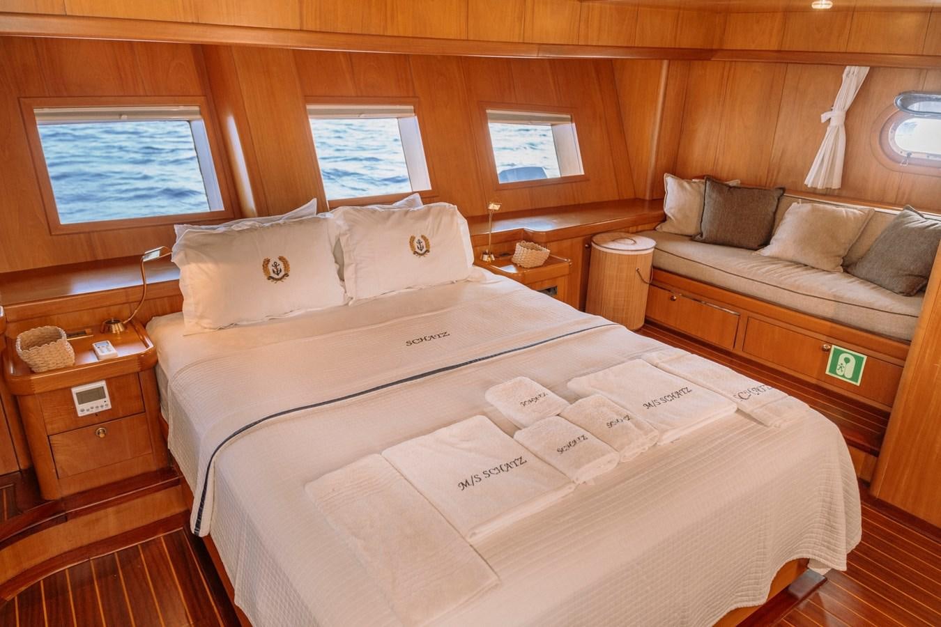 a bed with a white sheet and pillows aboard CUSTOM MADE MOTORSAILER Yacht for Sale