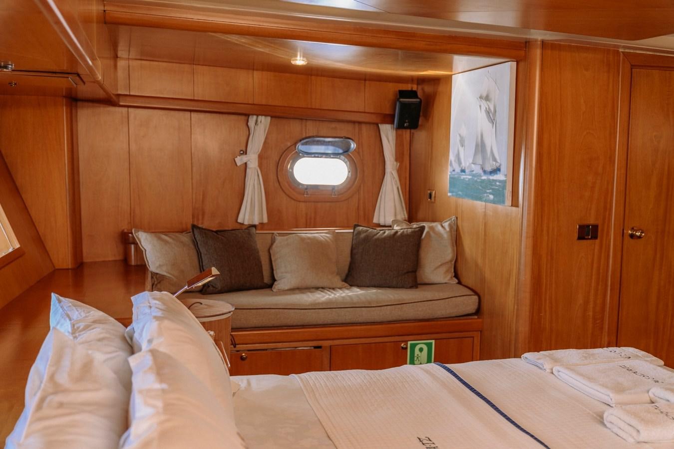 a room with a couch and a bed aboard CUSTOM MADE MOTORSAILER Yacht for Sale