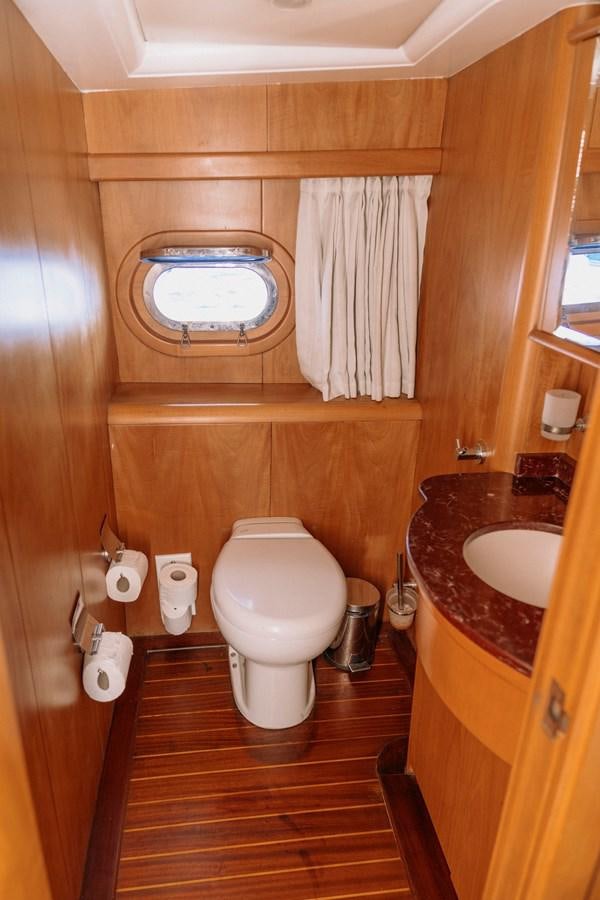 a bathroom with a toilet and sink aboard CUSTOM MADE MOTORSAILER Yacht for Sale
