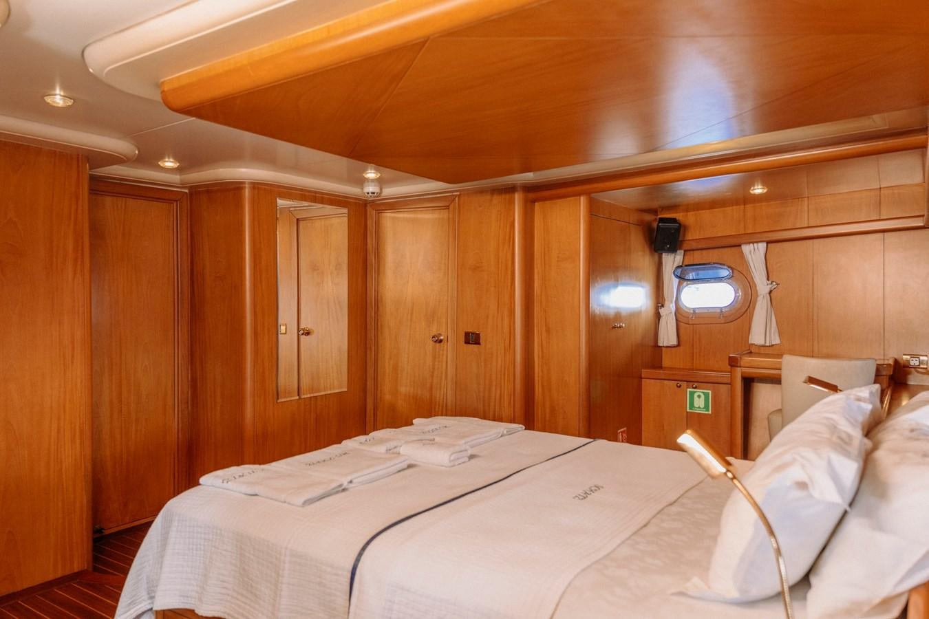 a room with wooden walls and a couple of beds aboard CUSTOM MADE MOTORSAILER Yacht for Sale