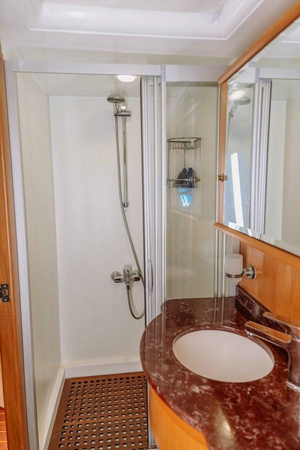 a bathroom with a sink and shower aboard CUSTOM MADE MOTORSAILER Yacht for Sale