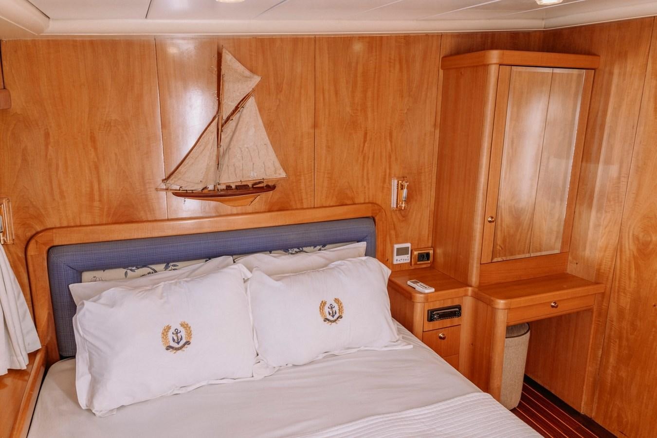 a bed with white sheets and pillows aboard CUSTOM MADE MOTORSAILER Yacht for Sale