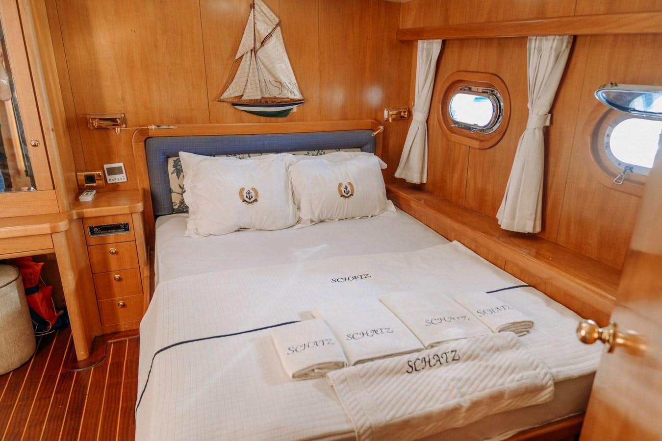 a bed with a white sheet and a white pillow aboard CUSTOM MADE MOTORSAILER Yacht for Sale