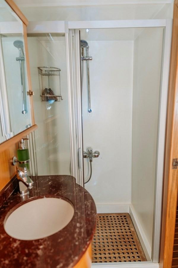 a bathroom with a sink and shower aboard CUSTOM MADE MOTORSAILER Yacht for Sale