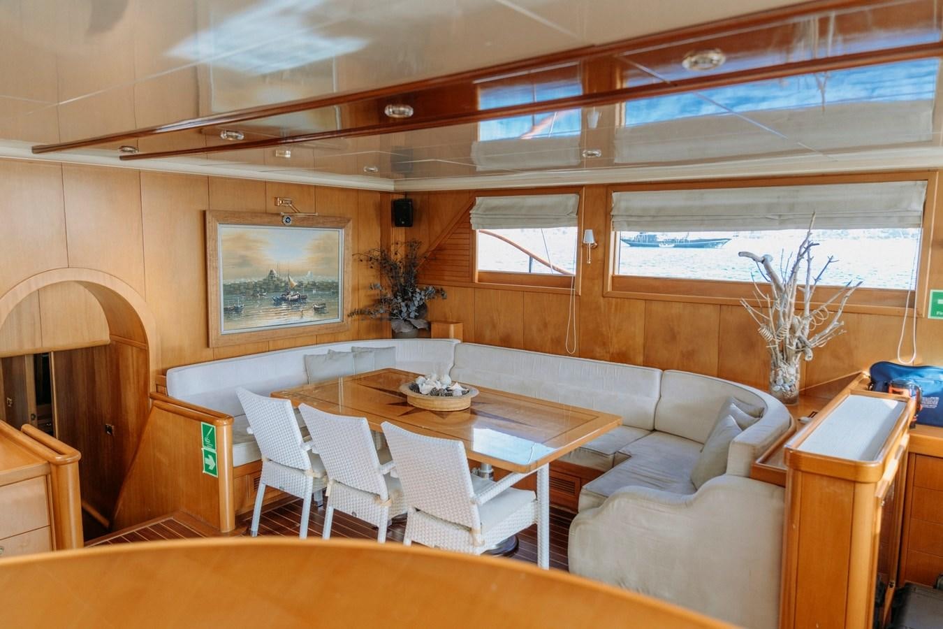 a room with a table chairs and a couch aboard CUSTOM MADE MOTORSAILER Yacht for Sale