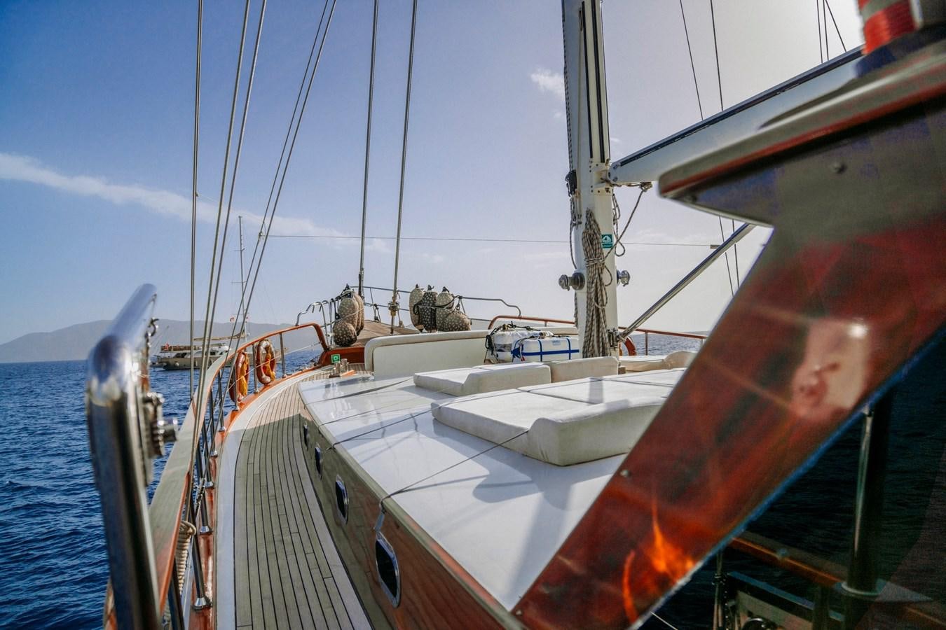 a boat with a large sail aboard CUSTOM MADE MOTORSAILER Yacht for Sale