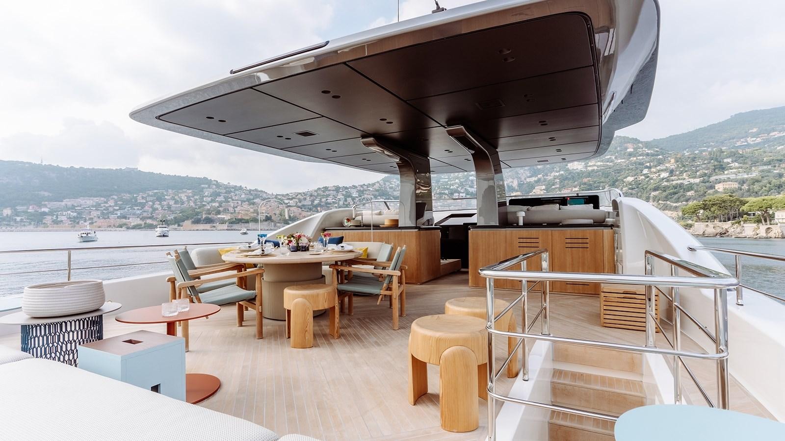 a room with tables and chairs aboard SAL Yacht for Sale