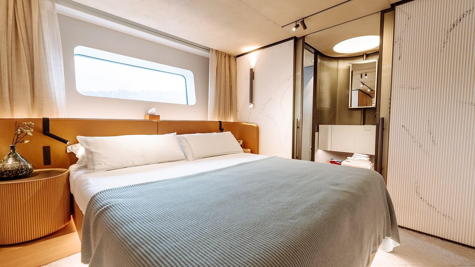 a bedroom with a bed and a desk aboard SAL Yacht for Sale