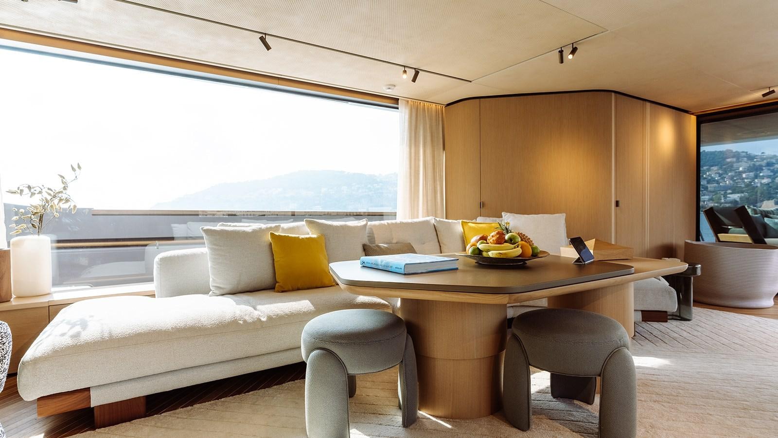a living room with a couch and a table aboard SAL Yacht for Sale