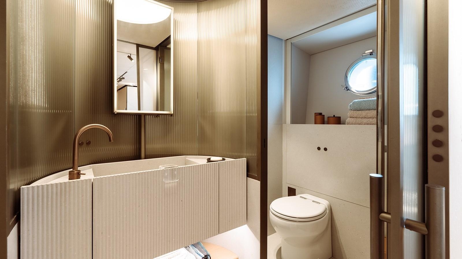 a bathroom with a tub sink and toilet aboard SAL Yacht for Sale