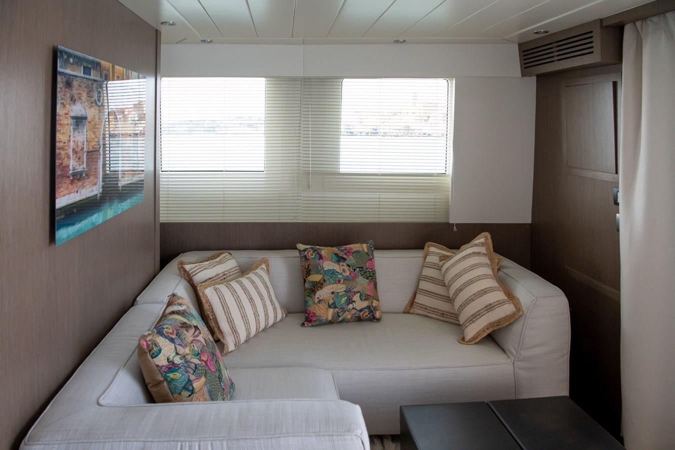 a couch with pillows on it aboard T88 Yacht for Sale