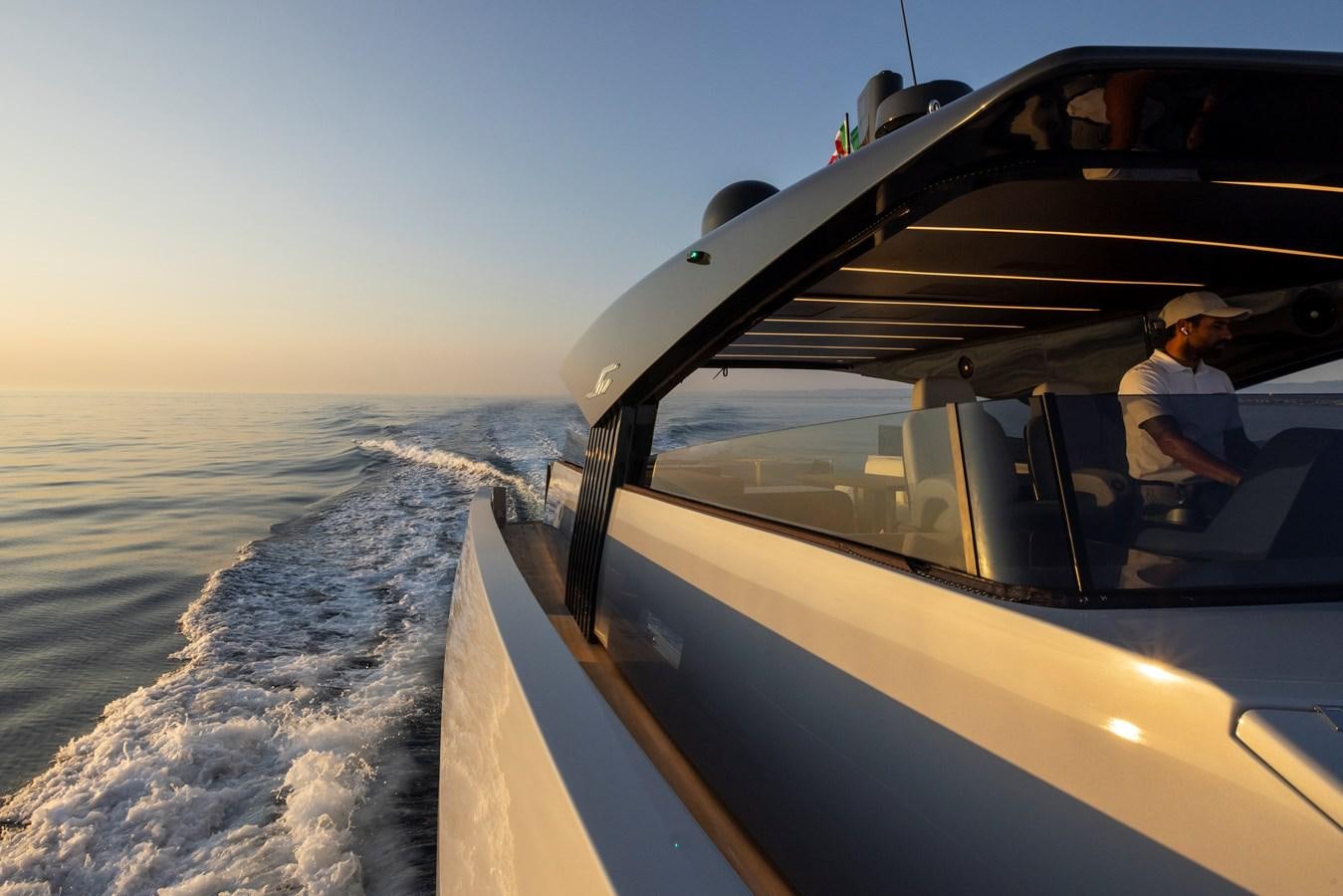 a person driving a boat on the water aboard S07 SPIDER Yacht for Sale