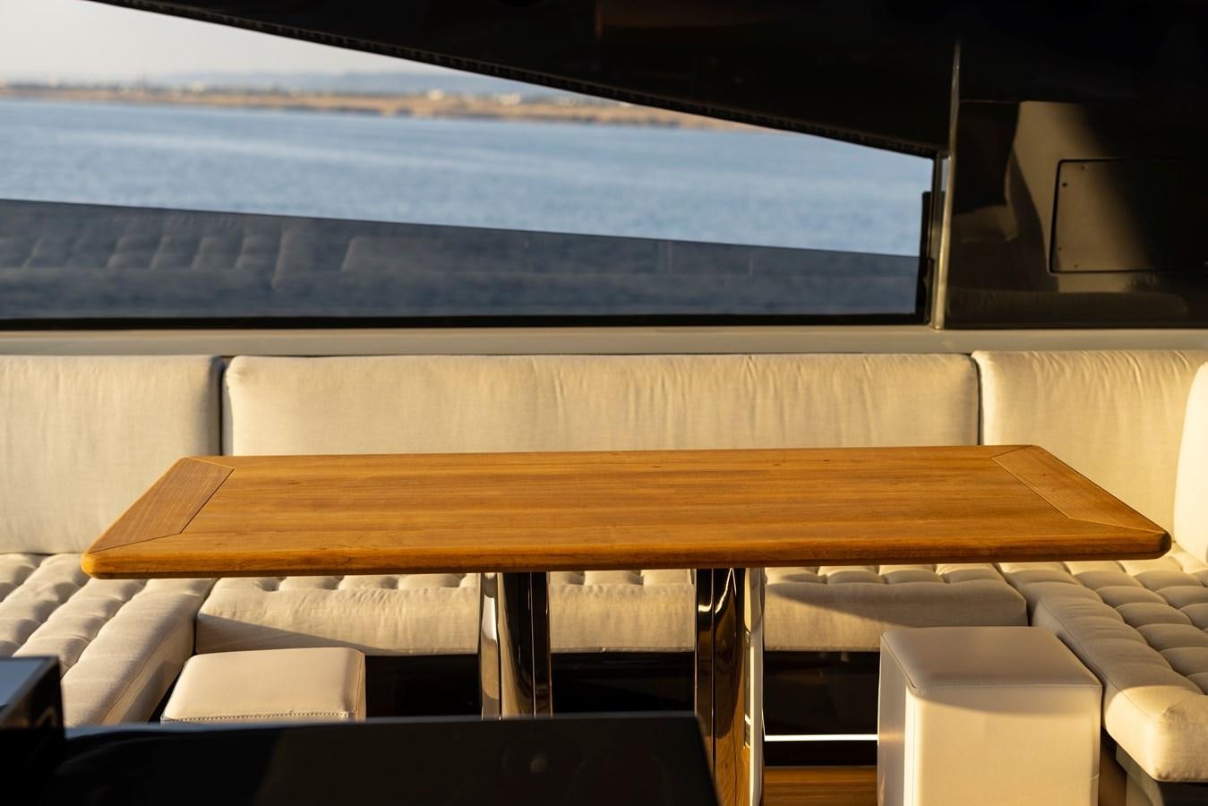 a wooden bench with white seats aboard S07 SPIDER Yacht for Sale