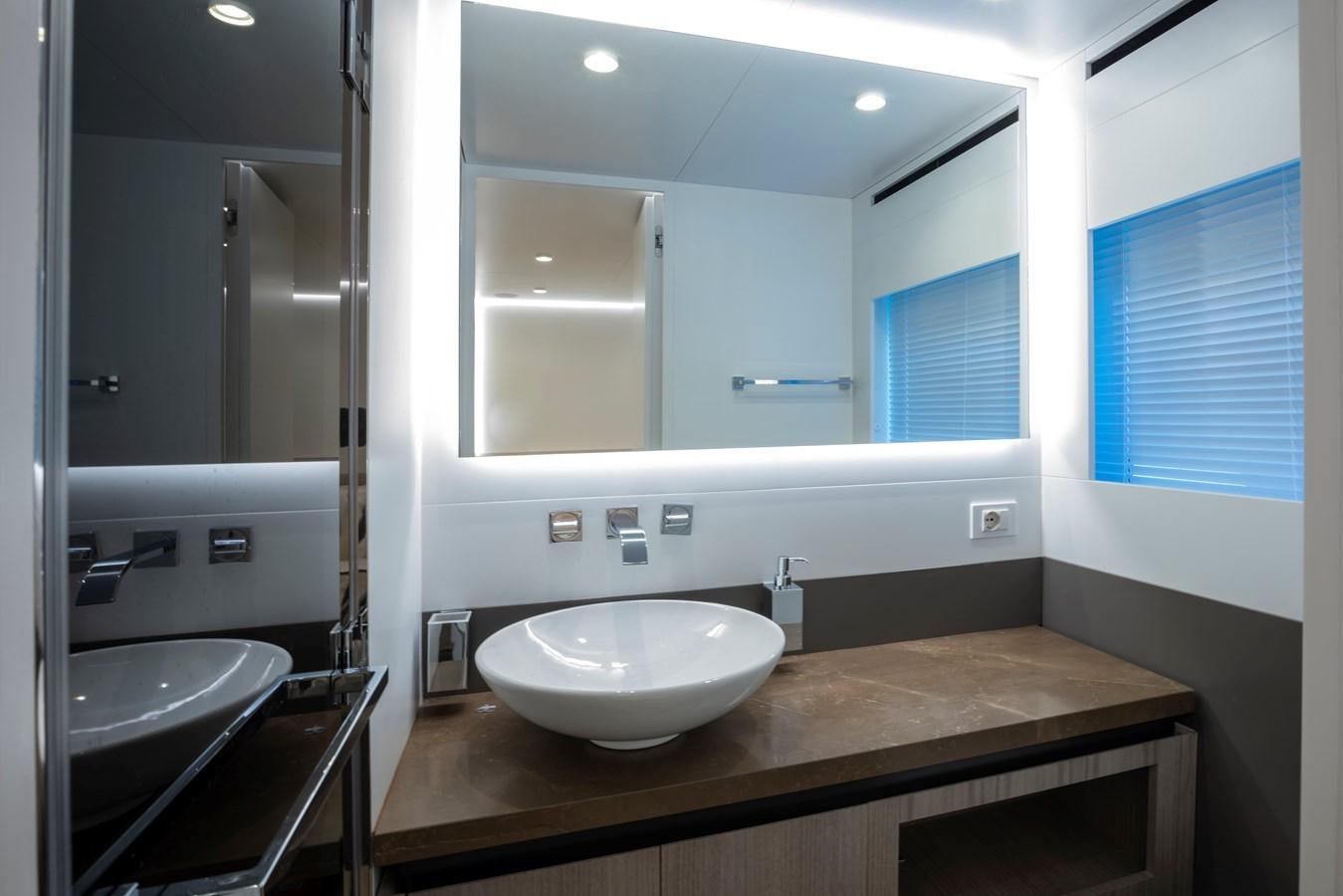 a bathroom with a countertop sink and a large mirror aboard S07 SPIDER Yacht for Sale