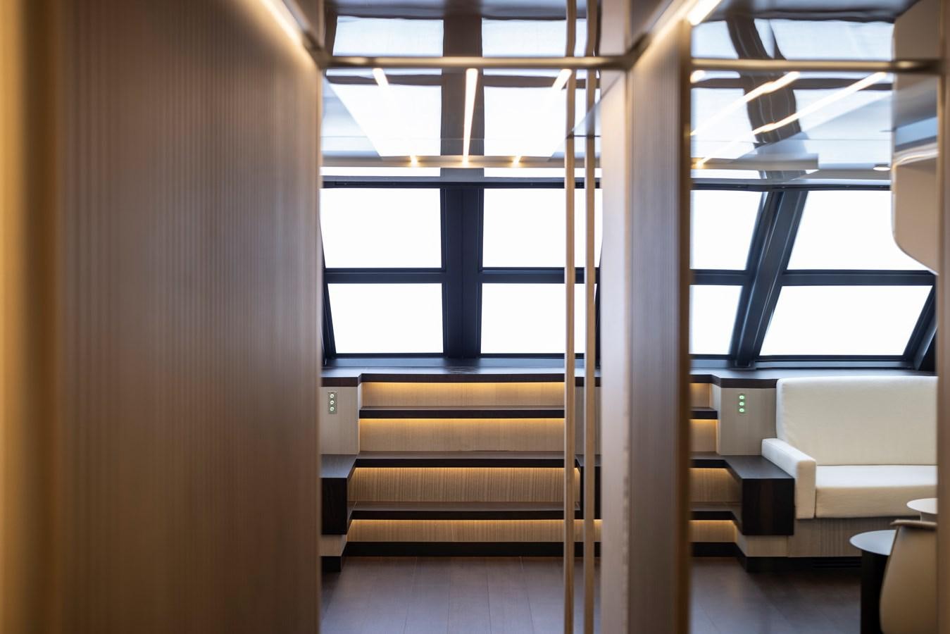 a room with a wood floor and a window with a view of the outside aboard S07 SPIDER Yacht for Sale