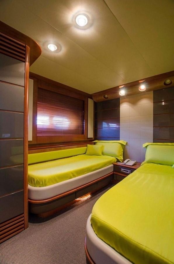a room with a couple of beds aboard DIVINE MADNESS Yacht for Sale