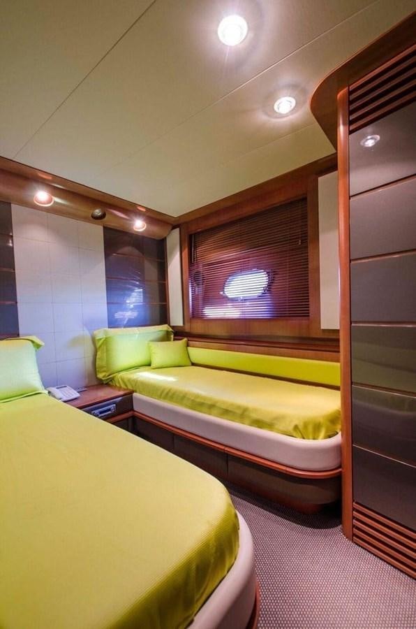 a room with a bed and a window aboard DIVINE MADNESS Yacht for Sale