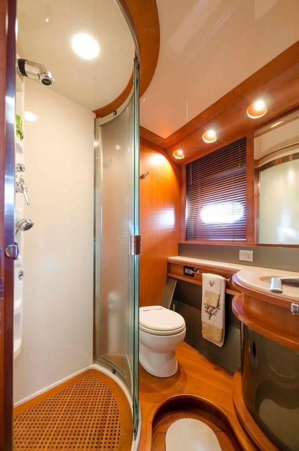 a bathroom with a toilet and sink aboard DIVINE MADNESS Yacht for Sale