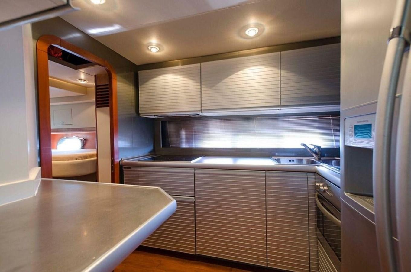 a kitchen with a large island aboard DIVINE MADNESS Yacht for Sale