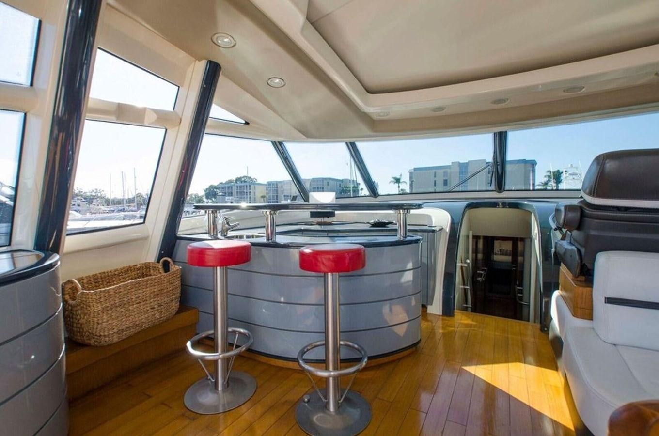 inside of a vehicle with a table and chairs and a bench aboard DIVINE MADNESS Yacht for Sale