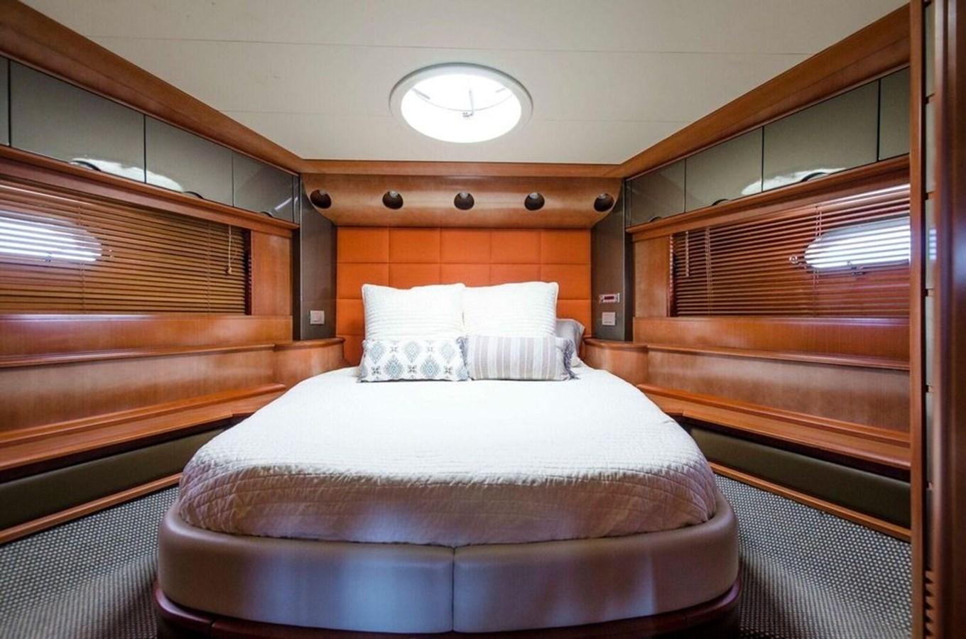 a bed with white sheets aboard DIVINE MADNESS Yacht for Sale