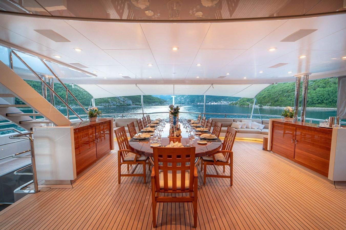 a large room with a table and chairs aboard TRIDENT Yacht for Sale
