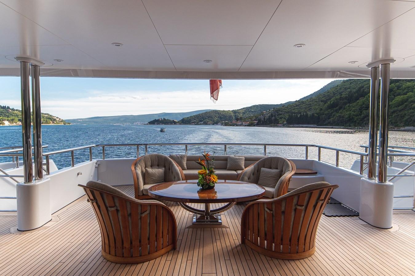 a table and chairs on a balcony aboard TRIDENT Yacht for Sale