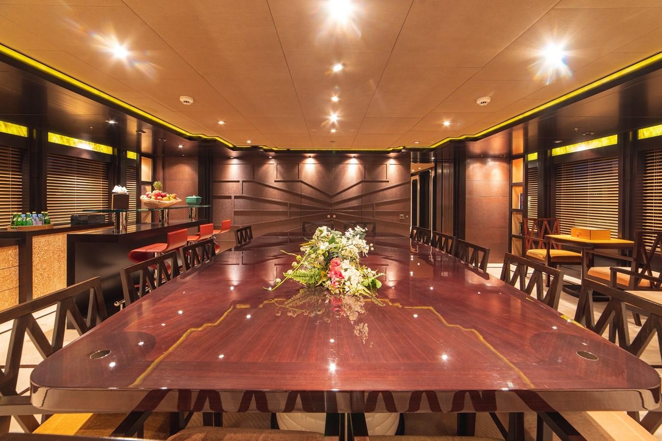 a large room with tables and chairs aboard TRIDENT Yacht for Sale