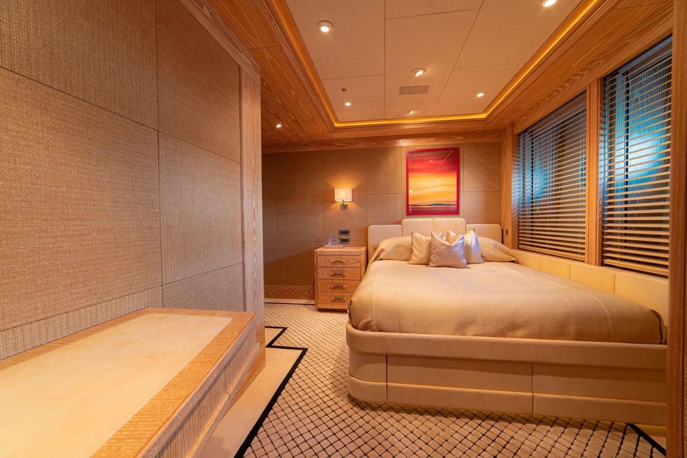 a bedroom with a bed and a window aboard TRIDENT Yacht for Sale