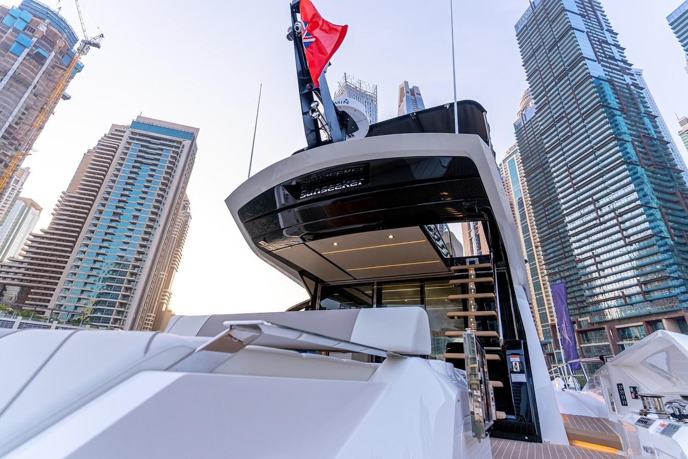 a group of buildings with flags aboard SUNSEEKER 65 SPORTS Yacht for Sale