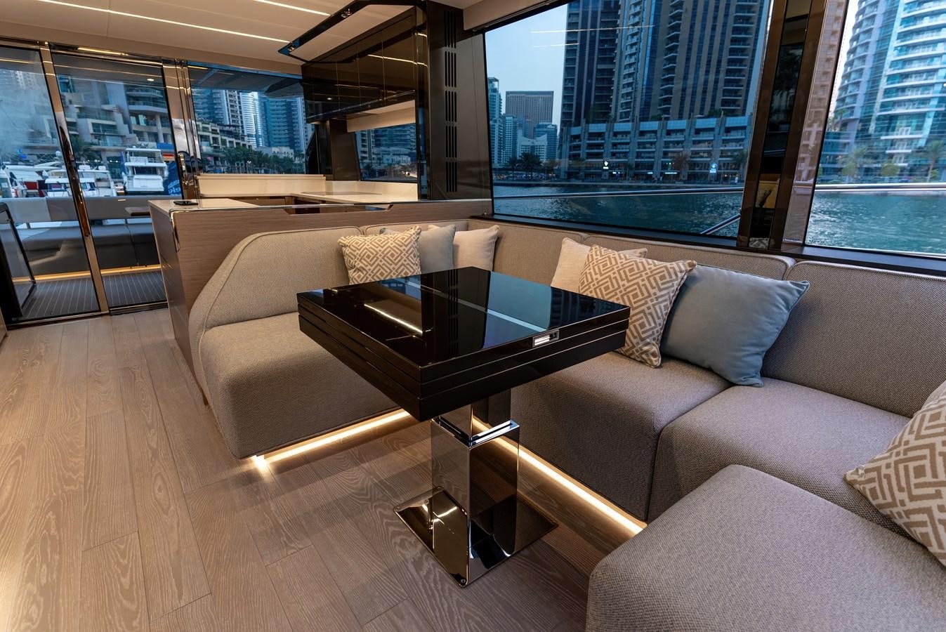 a living room with a large window aboard SUNSEEKER 65 SPORTS Yacht for Sale