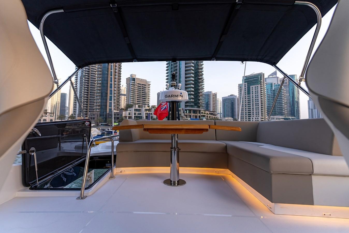 a table with chairs and umbrellas aboard SUNSEEKER 65 SPORTS Yacht for Sale