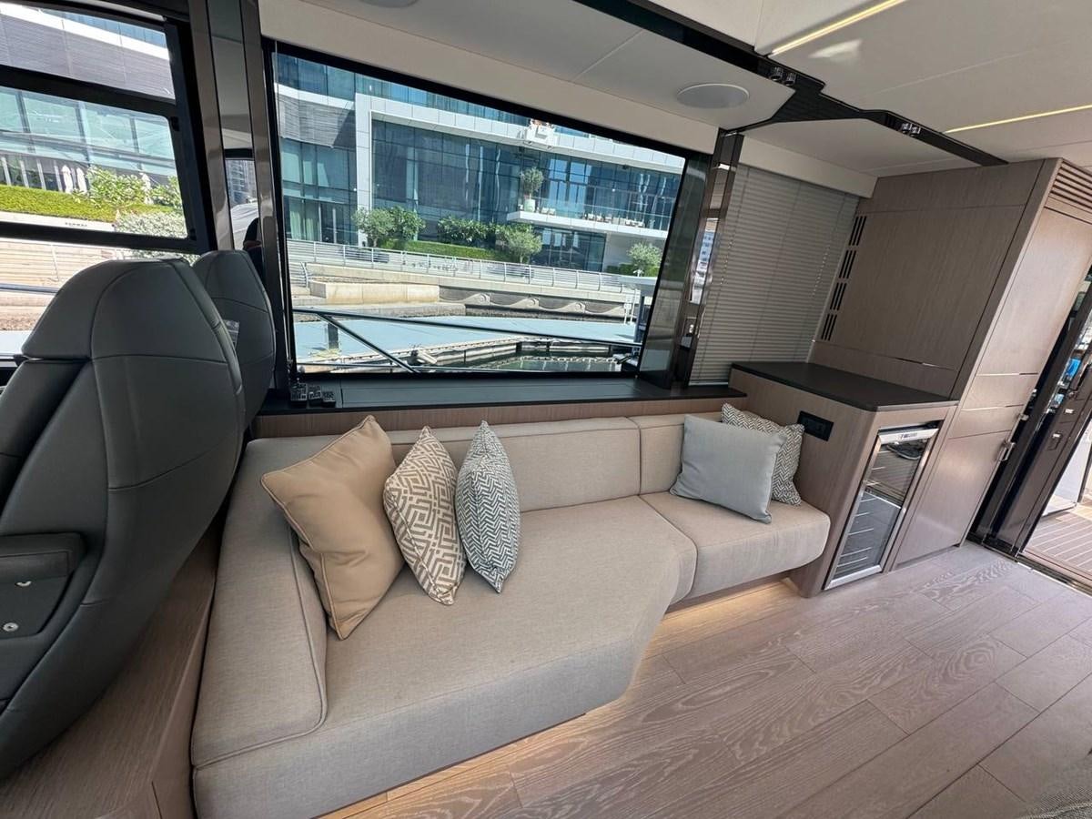 a living room with a large window aboard SUNSEEKER 65 SPORTS Yacht for Sale