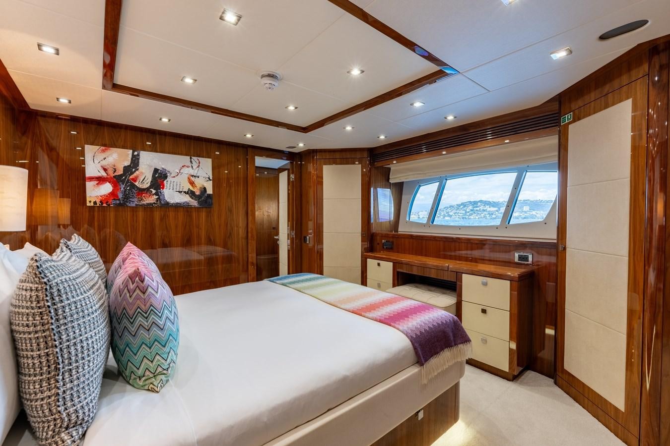 a bedroom with a bed and a desk aboard ANYA Yacht for Sale