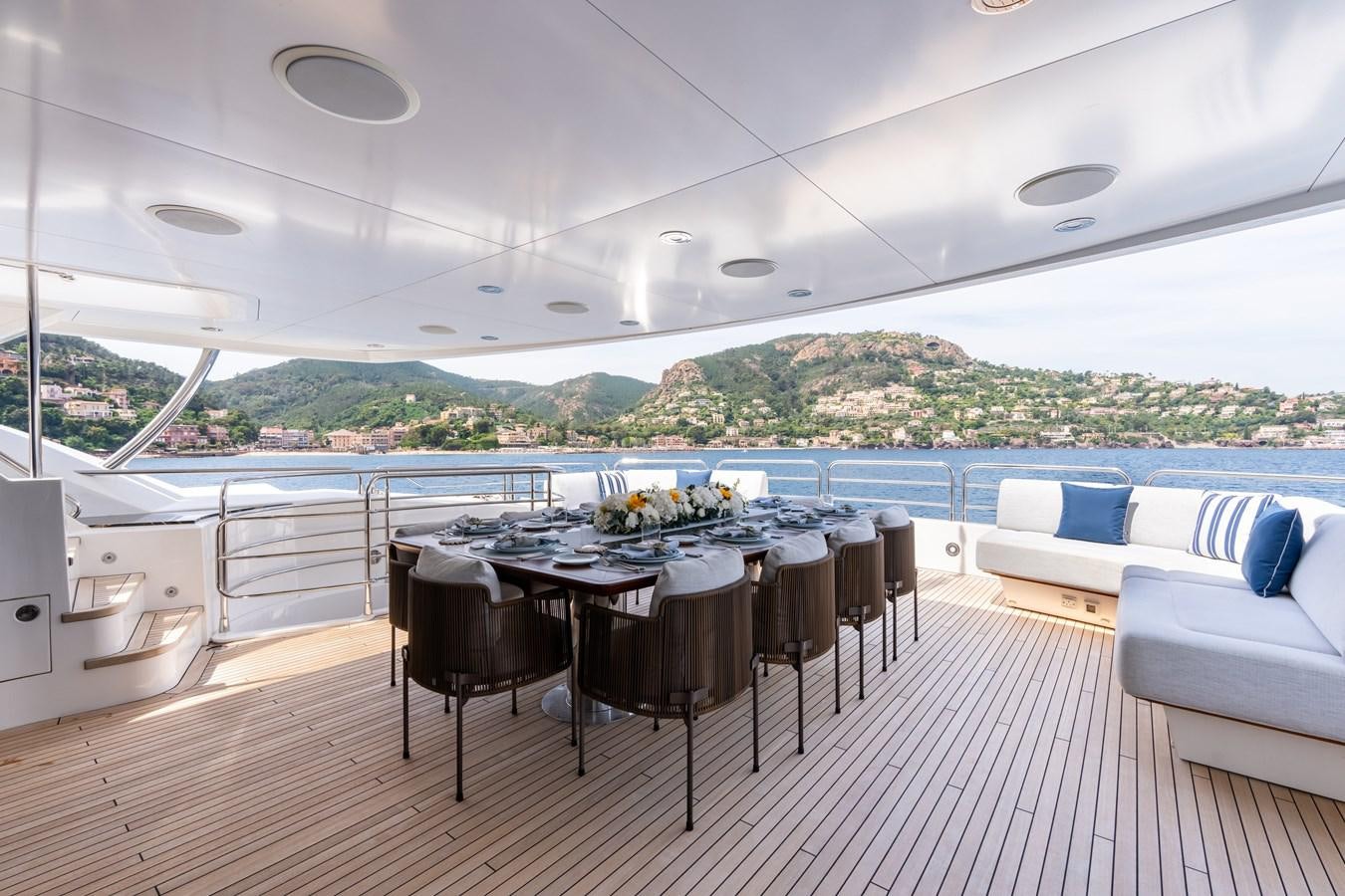 a large room with a table and chairs and a large window aboard ANYA Yacht for Sale