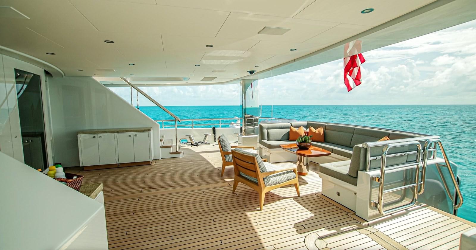 a large swimming pool with a table and chairs aboard W Yacht for Sale