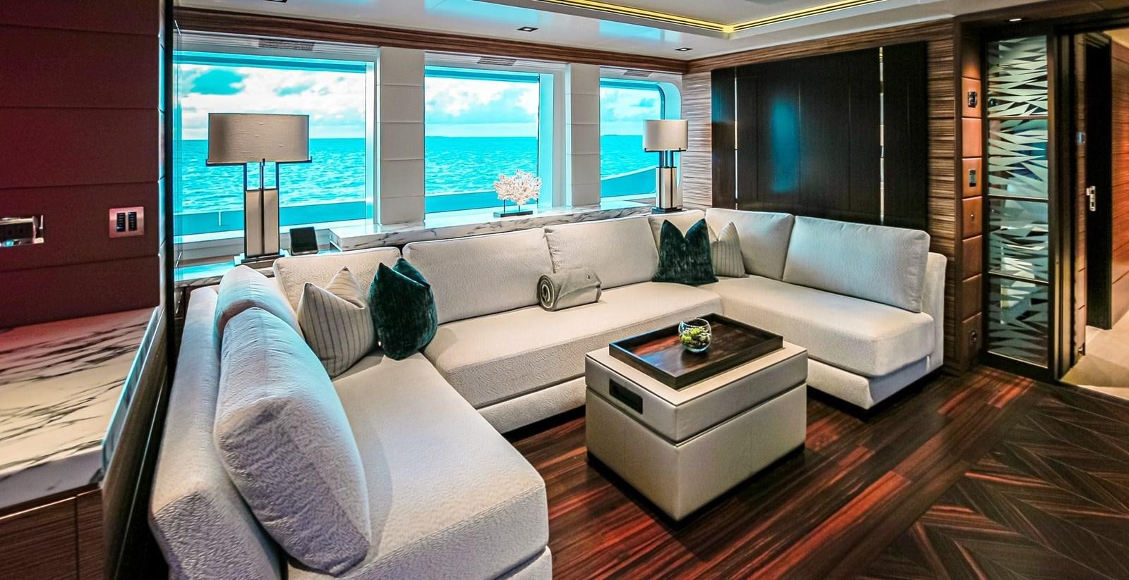 a living room with a couch and a coffee table aboard W Yacht for Sale
