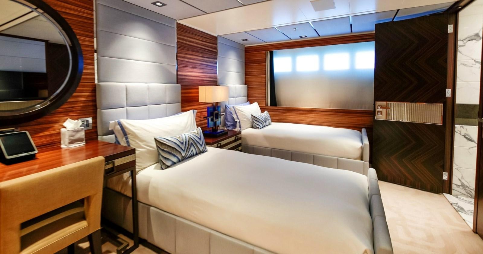a room with a bed and a desk aboard W Yacht for Sale
