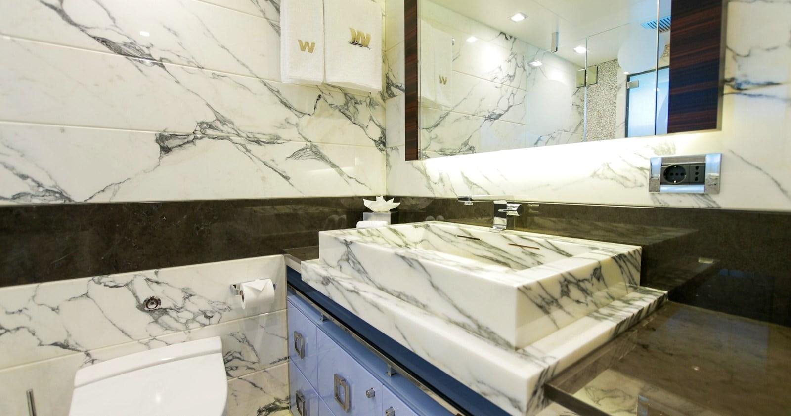 a room with a white wall and a blue cabinet with white cabinets aboard W Yacht for Sale