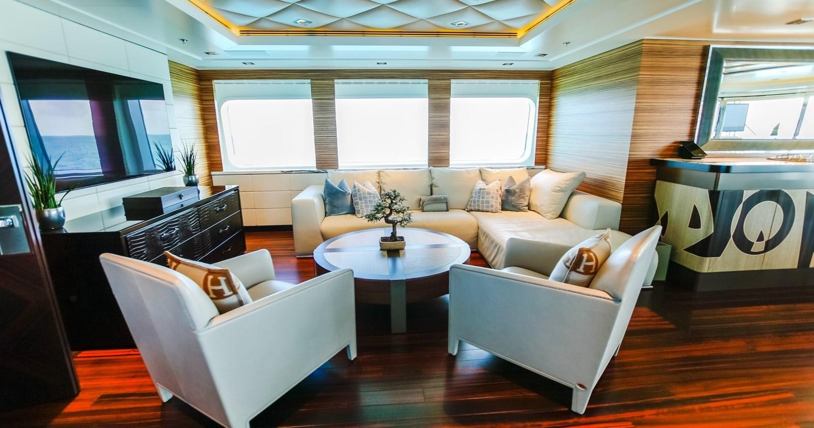 a living room with a couch and a table aboard W Yacht for Sale