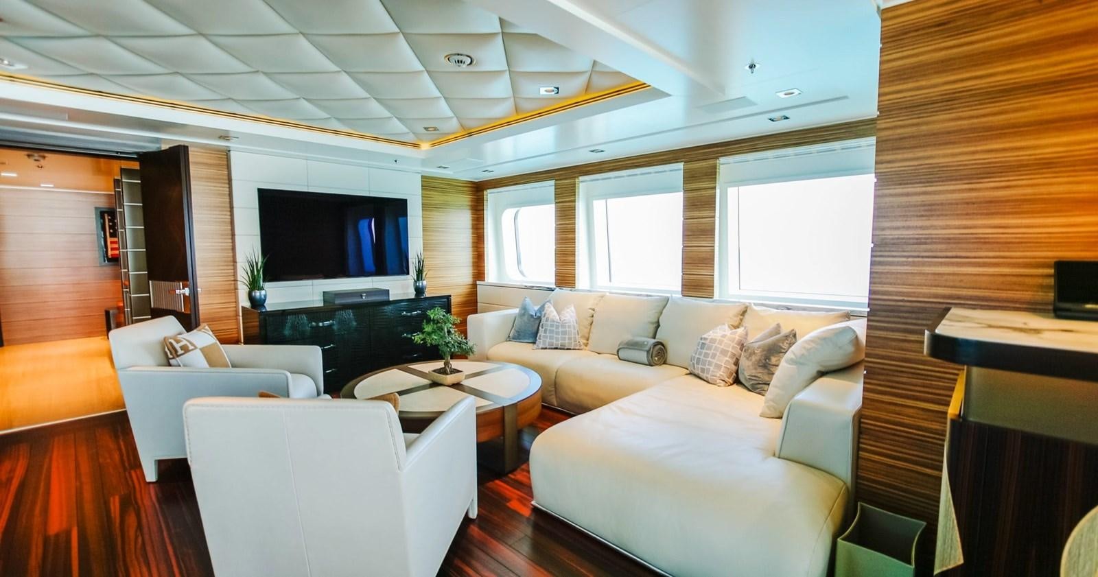 a living room with a couch and a television aboard W Yacht for Sale