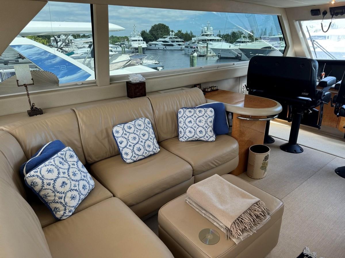 a living room with a couch and a table aboard DARE TO DREAM Yacht for Sale