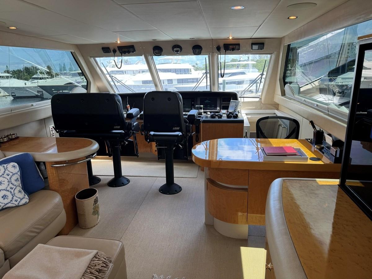 a room with a table and chairs aboard DARE TO DREAM Yacht for Sale